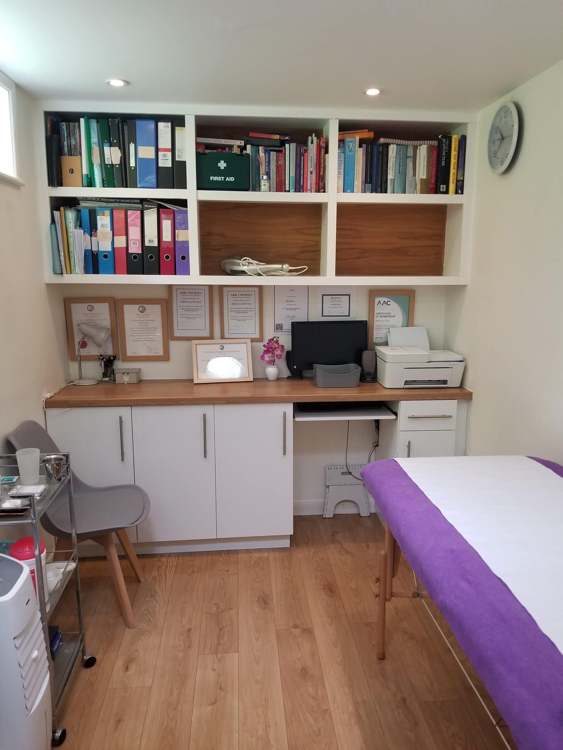 Acupuncture couch and bookshelf in dedicated home acupuncture treatment clinic